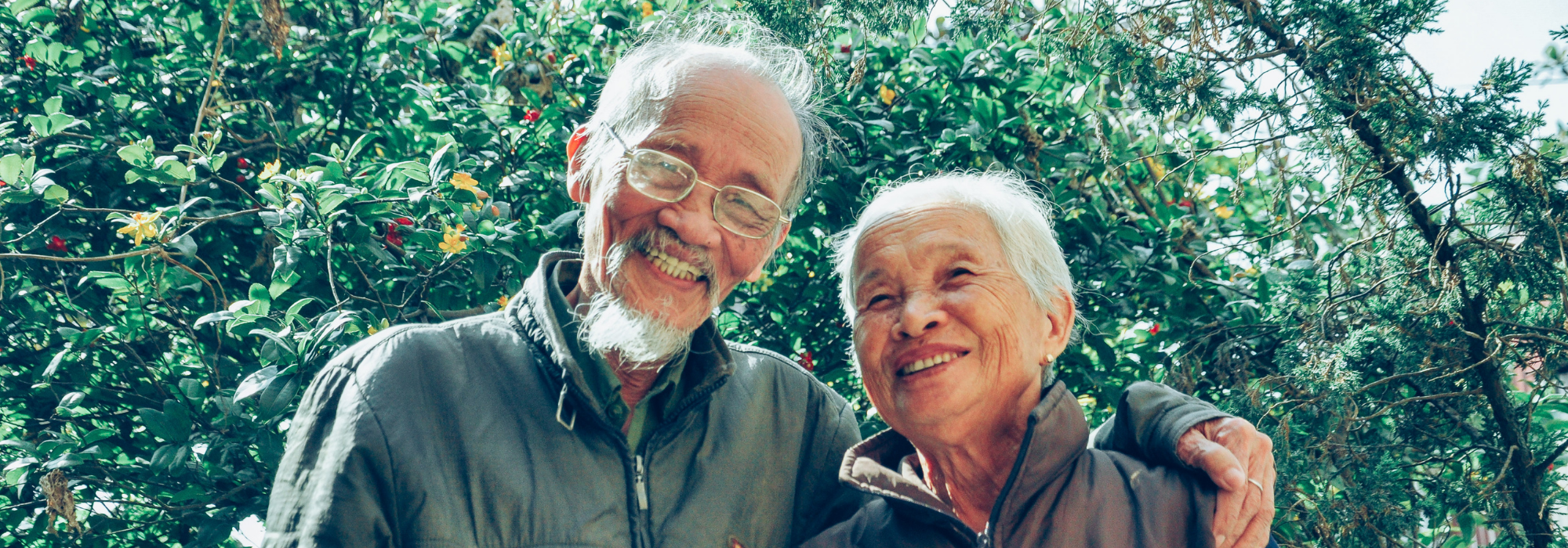 older couple smiling and embracing 